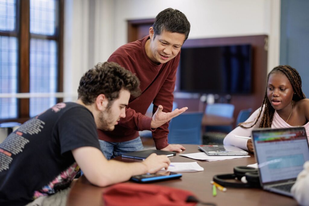 Two students collaborate at a table